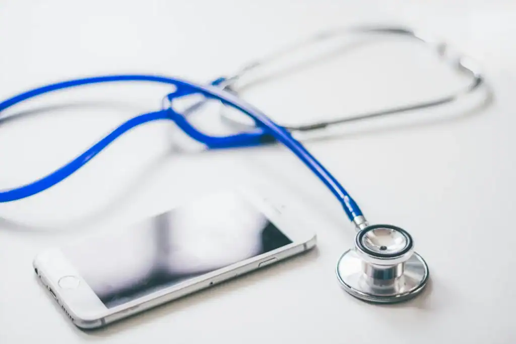 A smartphone lies next to a stethoscope, symbolizing how mobile technology is beginning to replace traditional heart checkups