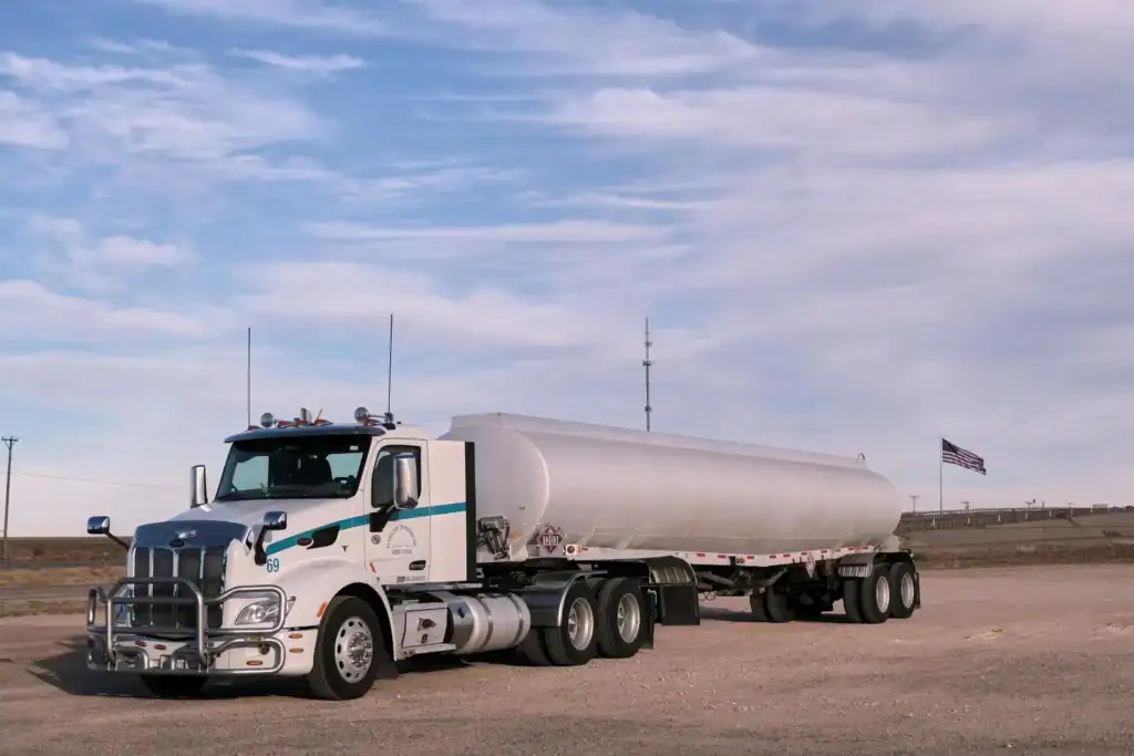 A large full tanker stands on the tarmac under a blue sky. Its huge size is notable.
