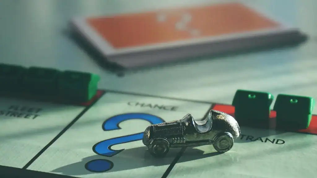 A metal monopoly car playing piece stands on the chance space of a monopoly board. It represents that genetics and lifestyle factors contrinute to a chance of developing neurodivergences. Not a certainty. 