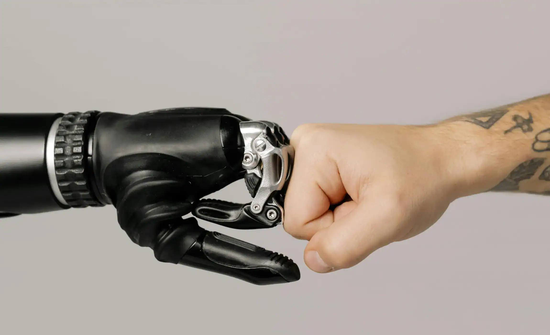 A human and a robot fist-bump. Symbolising the combined forces of humankind and cutting-edge technology.