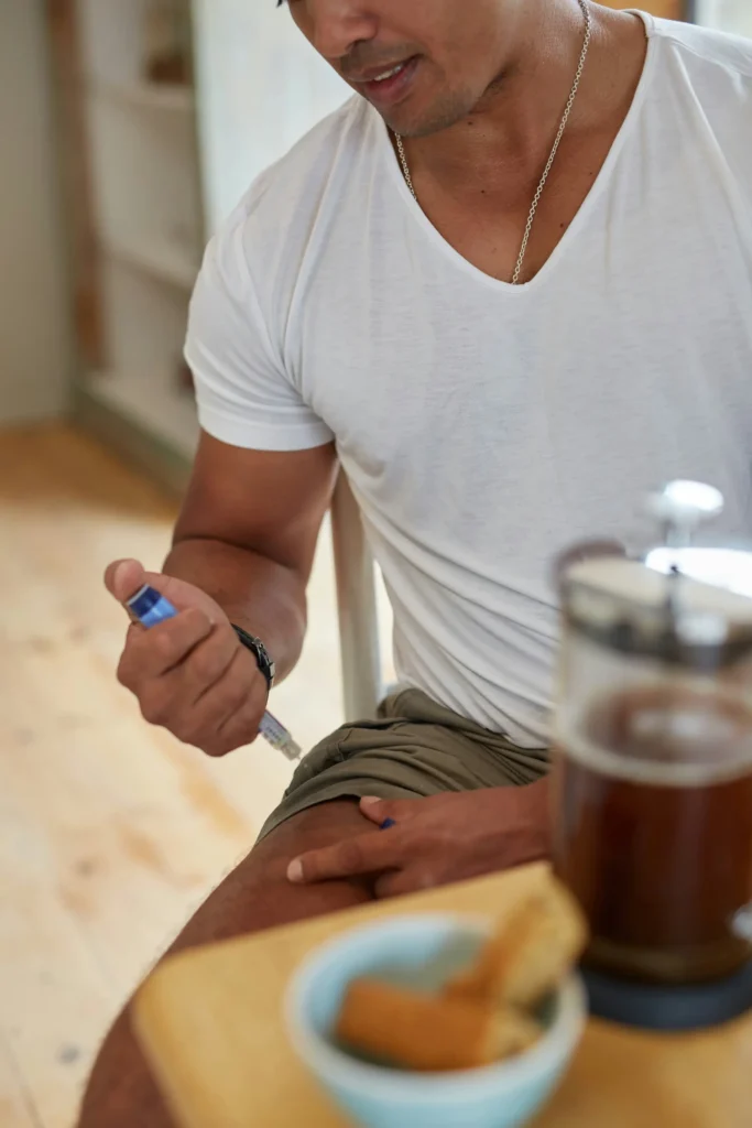 A man injects insulin into his leg