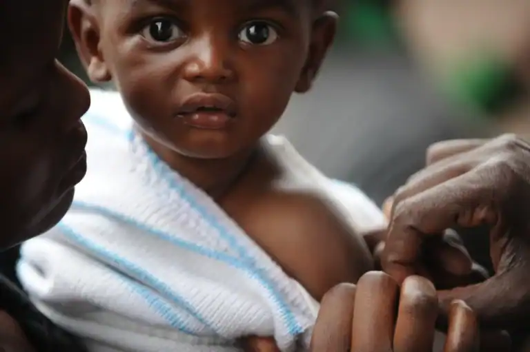A small child in Rwanda receives a vaccination