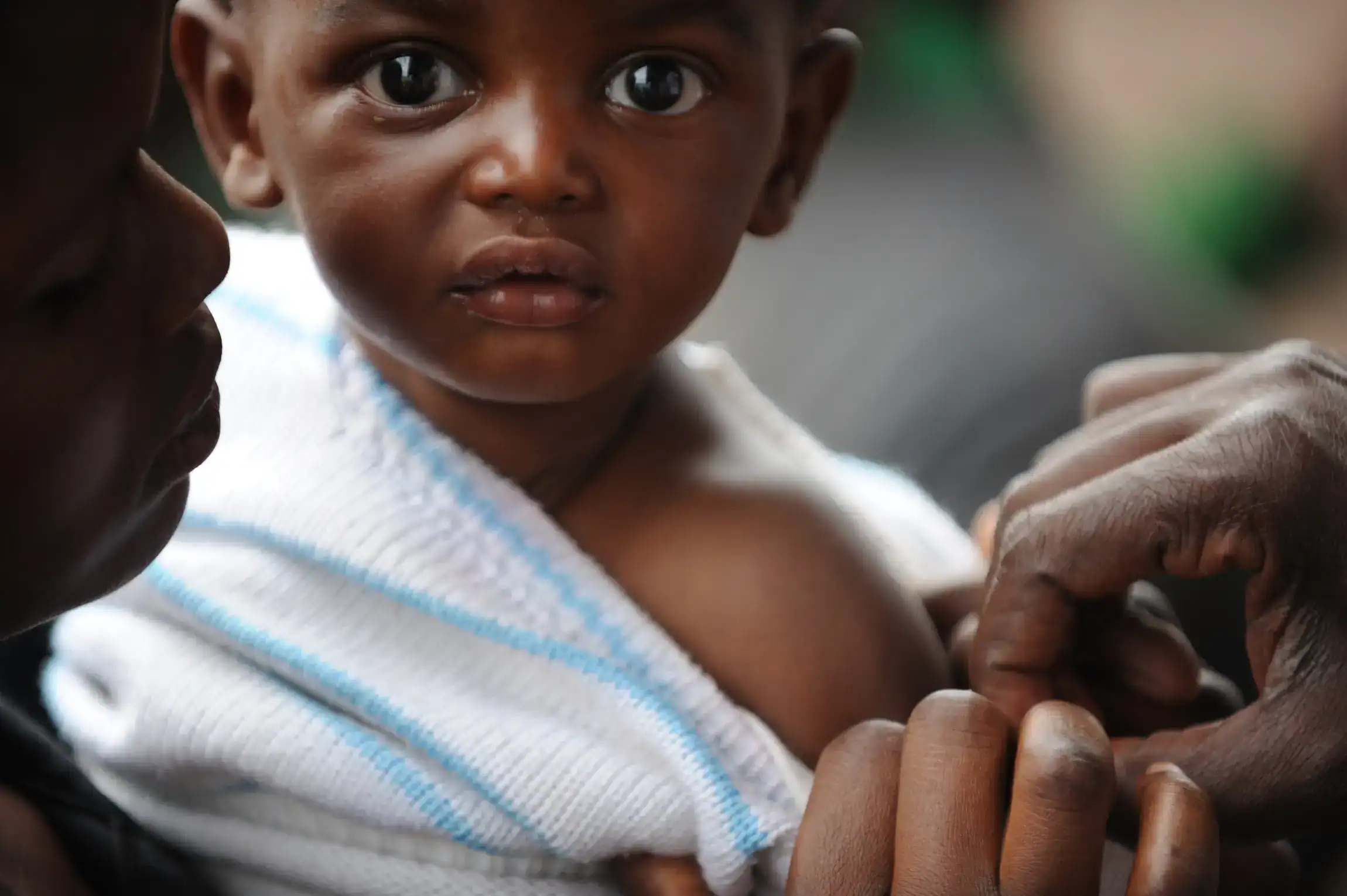 A small child in Rwanda receives a vaccination